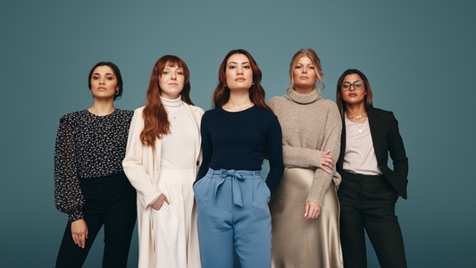 Confident women standing together in a studio