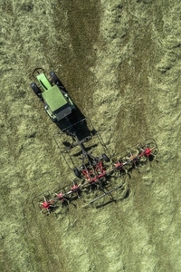 Aerial view tractor harvesting green hay crop Germany