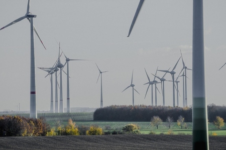 Wind turbines in idyllic rural countryside field Saxony Anhalt Germany