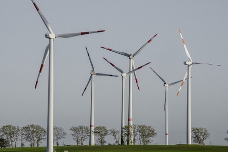 Wind turbine farms against sunny blue sky Germany
