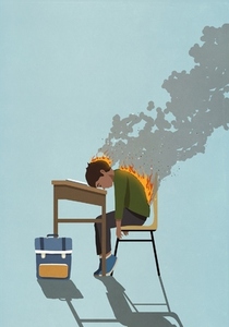 Exhausted school boy with back and head on fire sleeping at classroom desk
