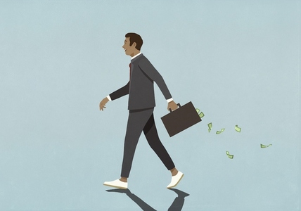 Businessman walking with money falling out of briefcase