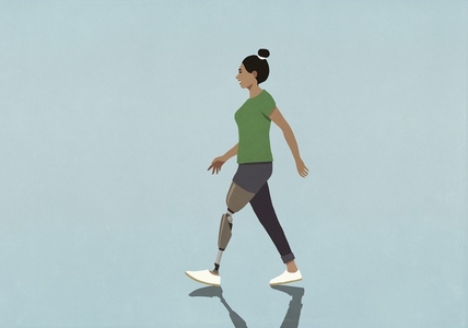 Woman with prosthetic leg walking against blue background
