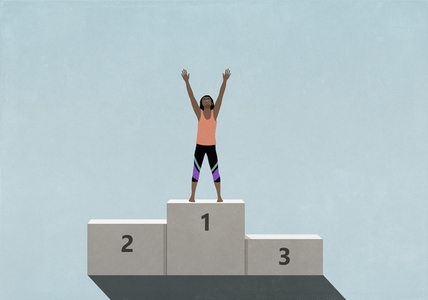 Victorious female athlete standing with arms raised