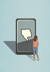 Sad girl standing next to thumbs down icon on smart phone screen