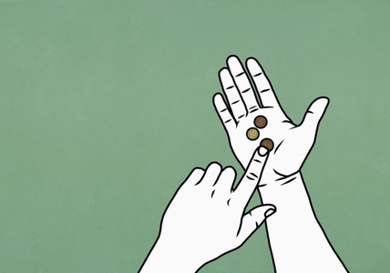 POV hand holding coins on green background