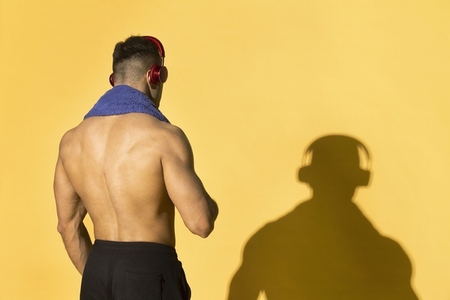 Rear view portrait athletic bare chested man after workout