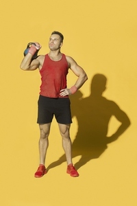 Studio portrait athletic man in red sportswear