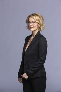 Studio portrait confident blonde businesswoman with eyeglasses in suit