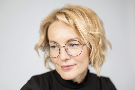 Close up portrait beautiful blonde woman in eyeglasses looking away