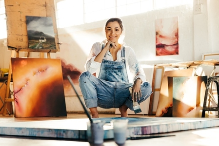 Carefree female painter working in her art studio