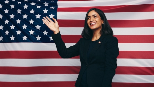 Patriotic congresswoman waving against an American flag