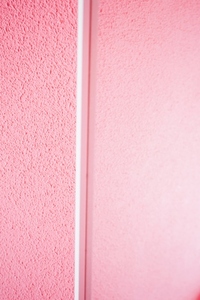 Minimal details in white in a pink room