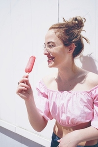 Young blonde woman enjoying an ice cream