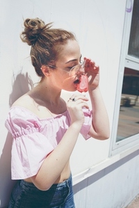 Young blonde woman enjoying an ice cream