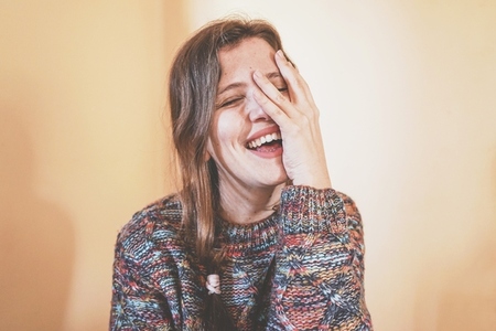 Emotional portrait of a real woman laughing