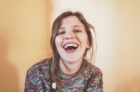 Emotional portrait of a real woman laughing