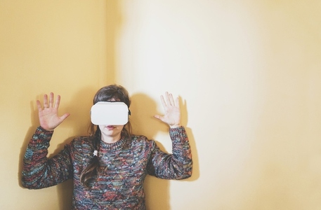Spontaneous portrait of a young woman using cardboard vr glasses