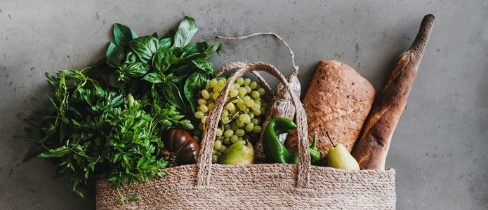 Flat lay of eco friendly bag with fresh foods  wide composition