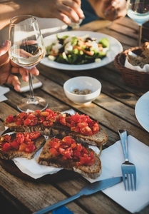 Dinner with salad  bruschetta with tomato and white wine