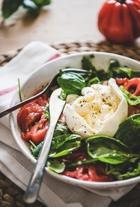 Italian salad with Buratta cheese in white bowl  selective focus
