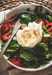 Italian salad with Buratta cheese in white bowl  close up