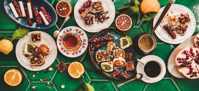 Turkish traditional lokum with tea and coffee over green tile