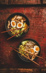 Japanese Ramen bowls with chicken meat and shiitake mushrooms