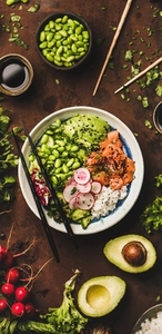 Salmon poke bowl or sushi bowl with vegetables  narrow composition
