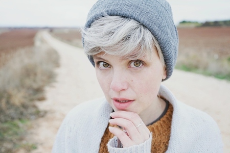 Woman with short and gray hair is alone in the beggining of a ru