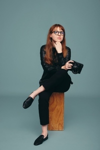 Female photographer sitting in a studio