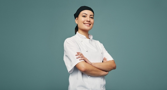 Cheerful chef smiling in a studio