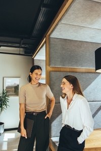 Businesswomen sharing a laugh in the office