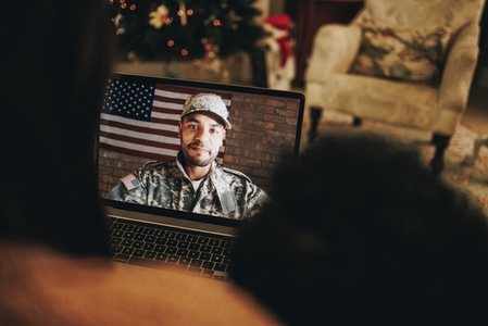 Military man video calling his family at Christmas