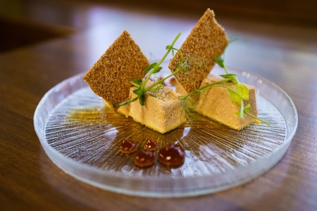 Plate of foie micuit with crispy croutons and drops of marmalade