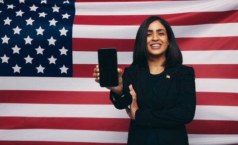 United States congresswoman holding up a smartphone