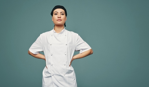 Female culinary chef standing in a studio