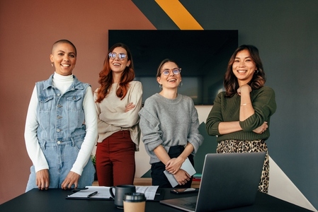 Successful female entrepreneurs smiling in a boardroom