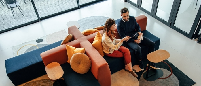 High angle view of two business colleagues working in a lobby
