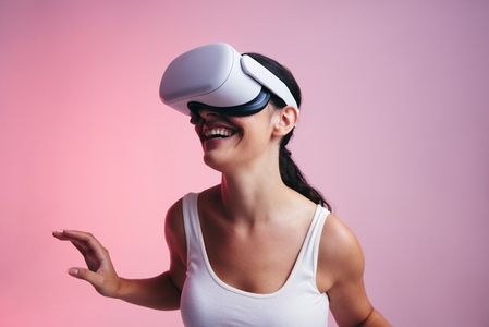 Happy young woman entering a fun virtual reality game