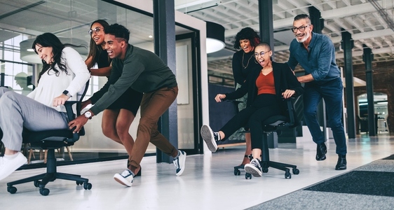 Cheerful coworkers enjoying playtime together at work