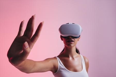 Woman touching virtual space with her hand in a studio