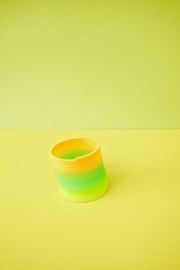 Isolated and colorful slinky toy in yellow orange and green tone