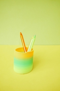 Colorful pens inside a colorful slinky toy