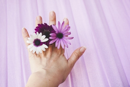 Woman hand using flowers as rings