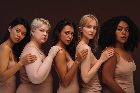 Group portrait of a young diverse women  Five females of different body types and races looking at camera in studio