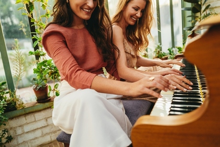 Friends playing the piano together