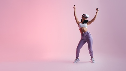 Happy young woman dancing in virtual reality