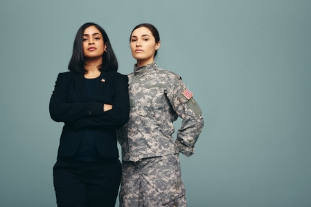 Congresswoman and servicewoman standing in a studio