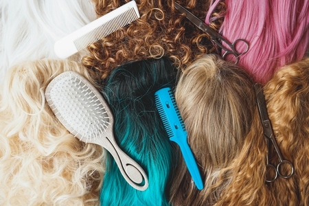 Hairdresser tools over a many color and natural wigs